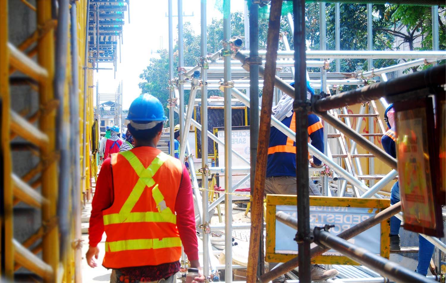 A construction worker from a service contracting company walking towards the site